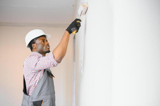 Painting work being completed on a wall