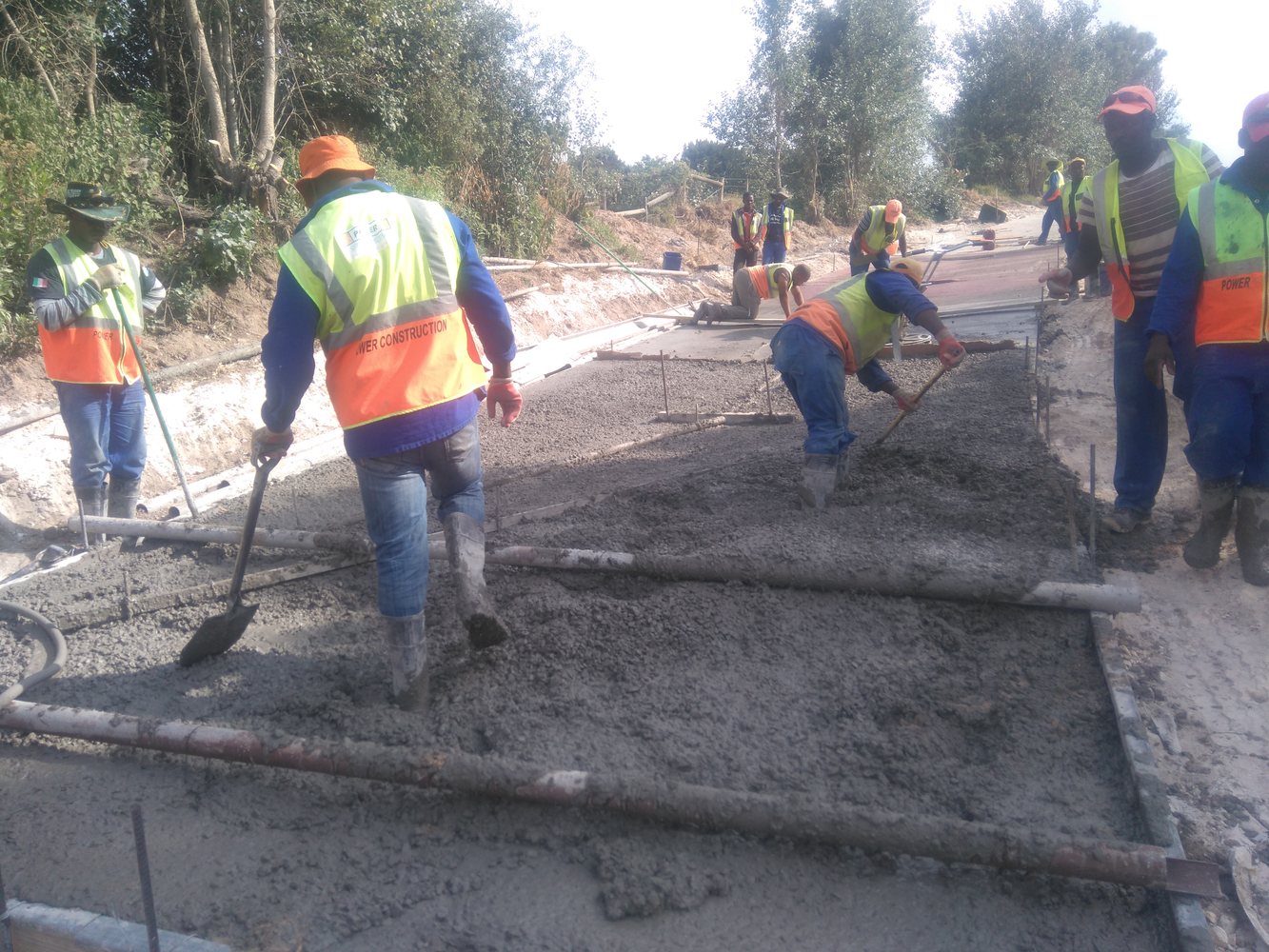 Road crew preparing a concrete pavement surface